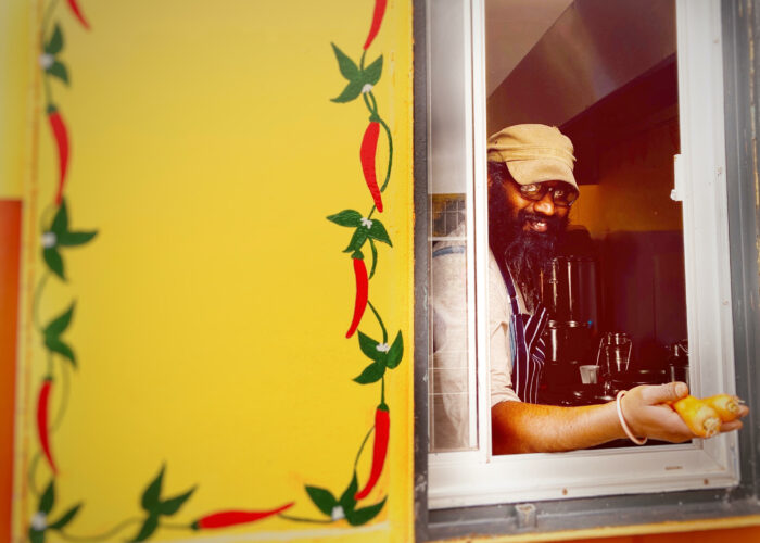 Chef looking through hatch on orange container where 11 chillies is